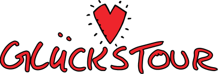 Logo der Glückstour mit stilisiertem roten Herz und handschriftlichem Schriftzug 'Glückstour